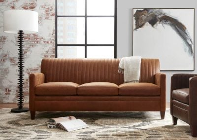 bradington young minimal living room with white lamp and brown sofa