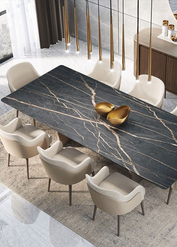 A top down view of a black and gold marbled Adriana Hoyos dining table