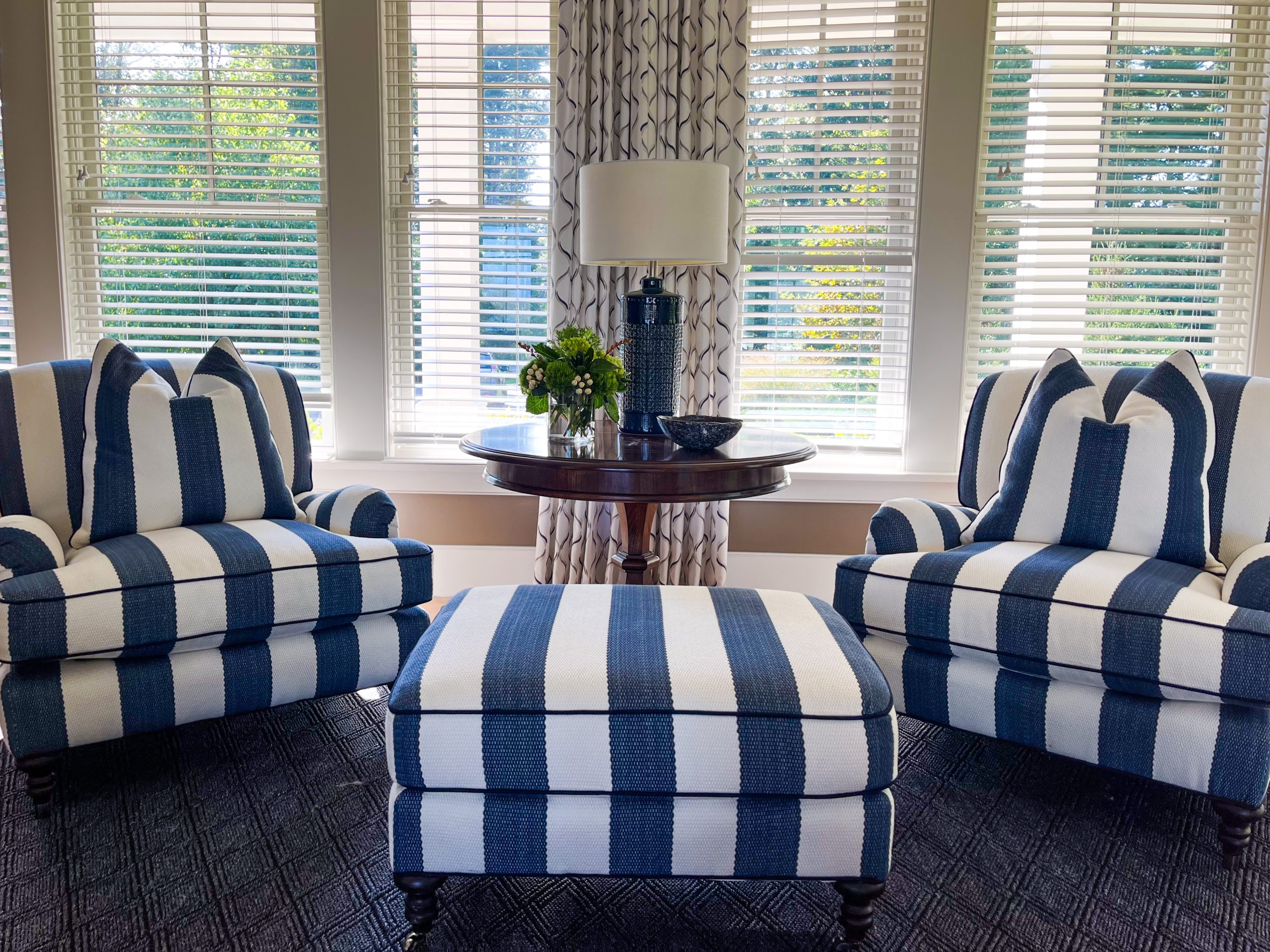 Navy blue and white striped armchairs and ottoman.