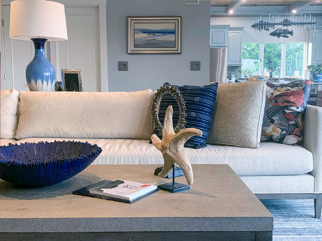 A coastal themed living room with a starfish decoration on a grey coffee table