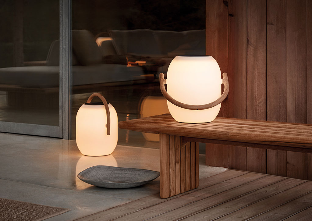 A pair of jar shaped soft lights with wooden handles on a modern wooden bench